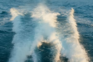 Boat wake trail across open water seen from above.