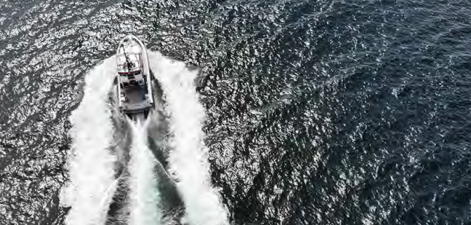 Boat cruising at high speed creating twin wake trails. Boat cruising at high speed creating twin wake trails.
