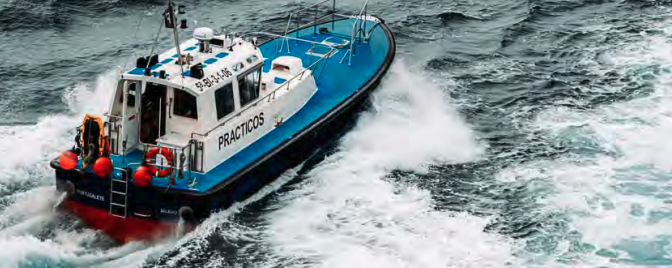 Small blue and white workboat speeding on water. Small blue and white workboat speeding on water.