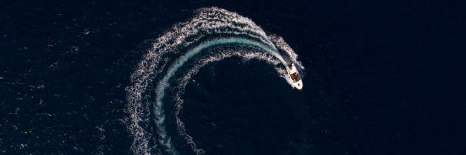High-speed vessel seen from stern creating large wake. High-speed vessel seen from stern creating large wake.