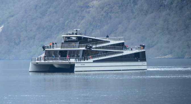 Sightseeing vessel cruising close to mountainside. Sightseeing vessel cruising close to mountainside.